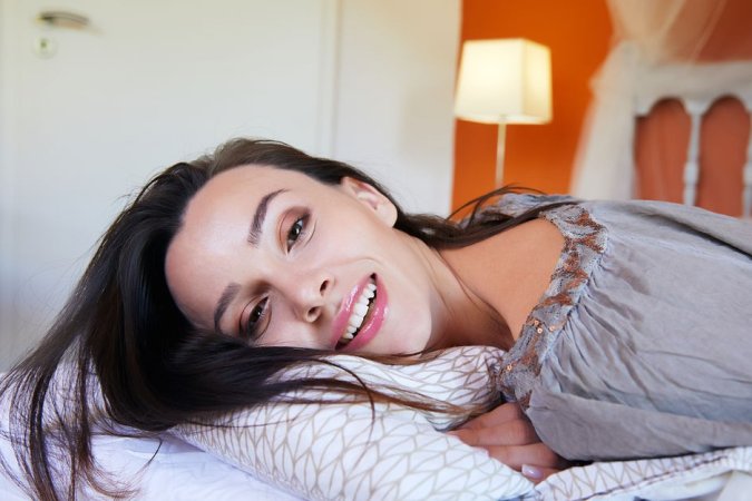 Dark-haired babe has a lot of fun in warm bed photo 4