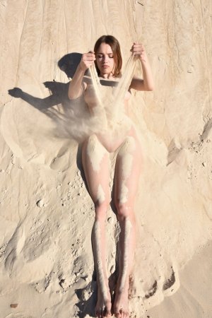 Curvy babe gets her orgasms in the sand photo 8