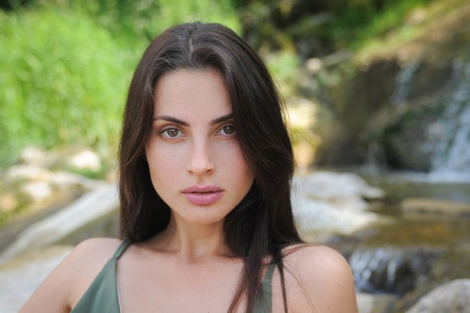 Slim brunette turns into a river nymph on the rock photo 17