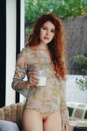 Ginger chick drinks milk and shows pussy at once photo 12
