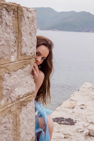 Brunette feels bored, so she undresses in ruins photo 13