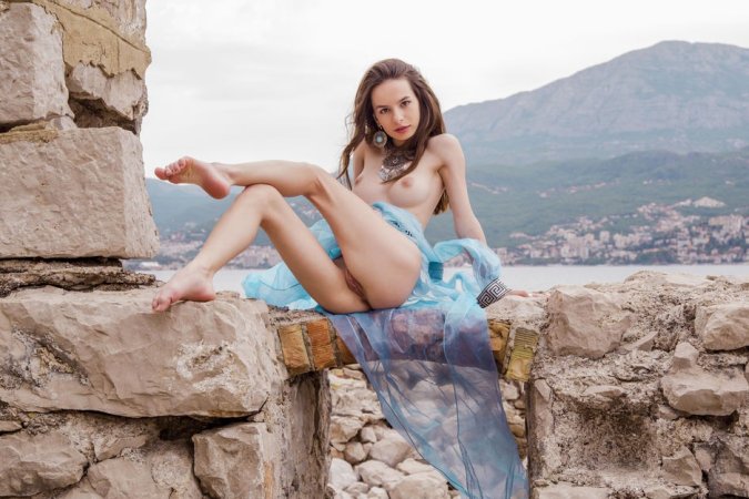 Brunette feels bored, so she undresses in ruins photo 15