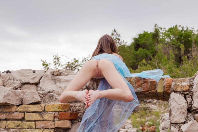 Brunette feels bored, so she undresses in ruins photo 18