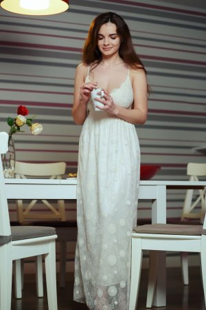 Hot smoking cutie with big boobs masturbates on table photo 2