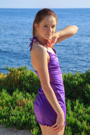 Cutie bares her small tits on a beach walk photo 1