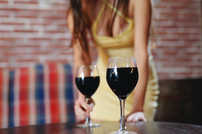 Dark-haired cutie enjoys wine and her own wet pussy photo 4