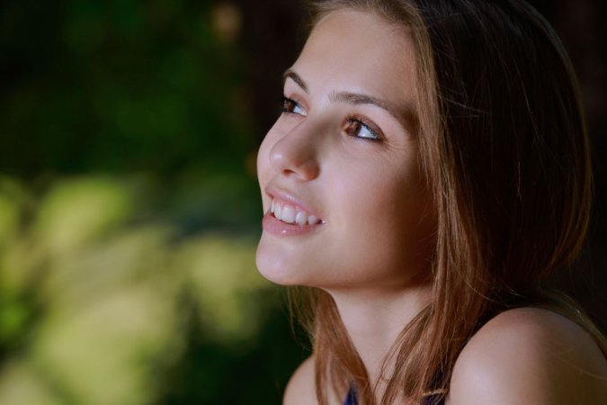 Brunette poses naked on a big tree photo 2