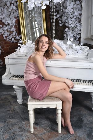 Brunette poses naked on the piano photo 9
