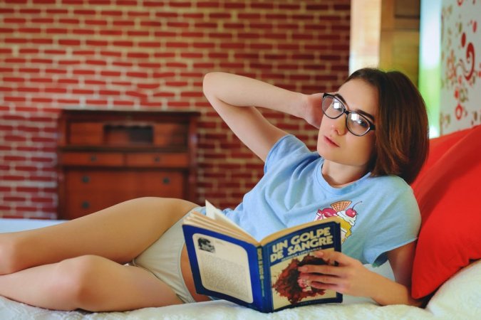 Naughty babe reads books and masturbates at once photo 16