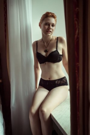 Red-haired chick takes off black lingerie set photo 17