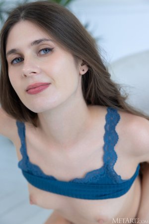 Luna Pica leans on the console table in a teal camisole photo 11