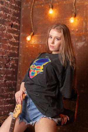 Lalli striptease in her industrial hideaway with a guitar photo 2