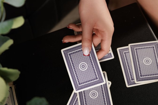 Kenelly plays cards on chair with spread legs photo 6