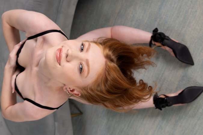 Sophia Mae stripteases on couch in sheer blouse photo 5